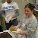 student holding a brain